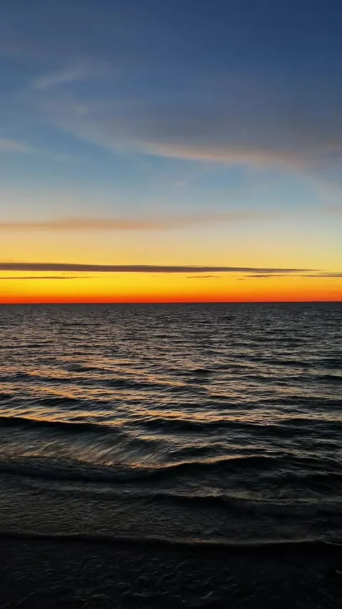 Vibrant Sunset Over Calm Ocean Waves Orange Blue Sky Stock Footage 317629126