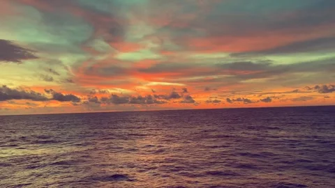 Vibrant sunset over calm ocean waves with colorful clouds in the sky creati.. Stock Footage 338281701
