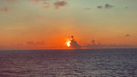 Vibrant sunset over a calm ocean with colorful sky and scattered clouds ref.. Stock Footage 338282033