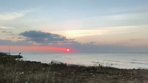 Vibrant Sunset over Calm Ocean Horizon with Red Sun and Clouds Stock Footage 341505535