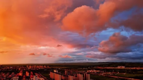 Vibrant Sunset Over Cityscape and Distant Mountains Xilingol Inner Mongolia Stock Footage 346588278