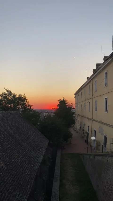Vibrant sunset over the Novi Sad skyline viewed from the Petrovaradin Fortress Vídeos de archivo 343567595