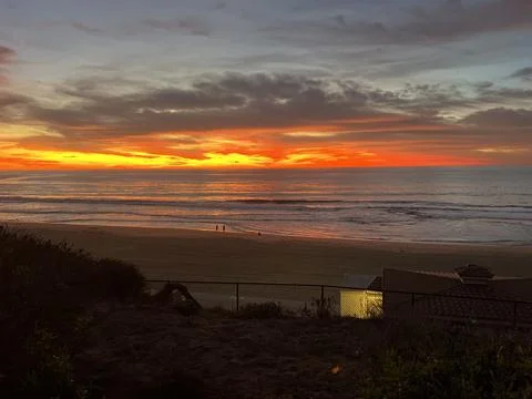 Vibrant Sunset Over the Ocean Creates a Magical Evening by the Beach Stock Photos