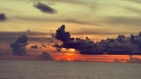 Vibrant sunset over the ocean with dramatic clouds painting the sky in oran.. Stock Footage 338282223