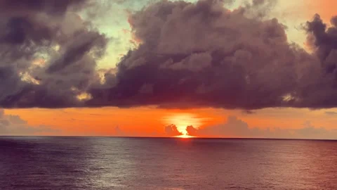 Vibrant sunset over the ocean with dramatic clouds creating a captivating a.. Stock Footage 338282471