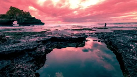 Vibrant Sunset over Ocean Rock Formation with Tide Pool Reflection Stock Footage 308281563