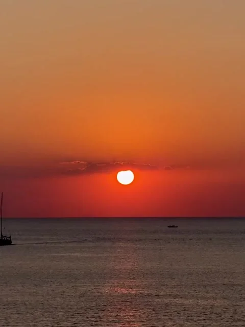 Vibrant Sunset Over Ocean With Silhouetted Boats Video stock 341268635
