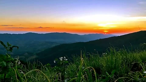 Vibrant Sunset Over Rolling Mountain Ranges Stock Footage 310244937