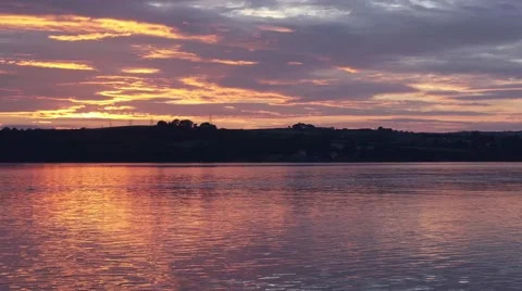 Vibrant sunset over tide coming in on estuary Stock Footage 66776935