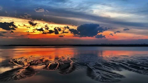 Vibrant Sunset Reflection on Tidal Sand Patterns of Qiantang River China Stock Footage 342603929