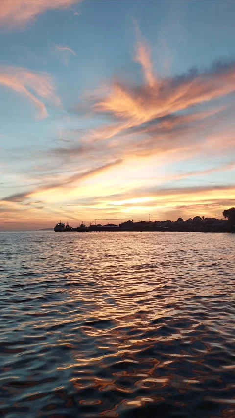 Vibrant Sunset Skies Reflecting on Ocean Ripples. Stock Footage 346354869