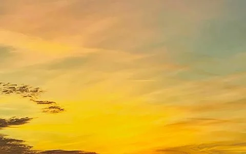 Vibrant sunset sky with dramatic clouds and warm colors painting the atmosphe Stock Photos