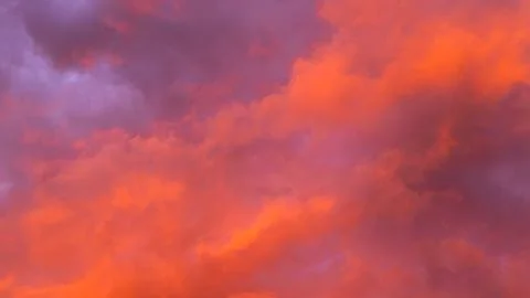Vibrant sunset sky with dramatic clouds displaying shades of orange, pink, an Stock Photos