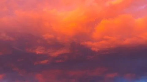 Vibrant sunset sky with dramatic clouds displaying shades of orange, pink, an Stock Photos