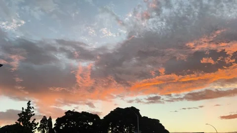 Vibrant sunset sky with dramatic orange and blue clouds New Zealand Stock Footage 331259384