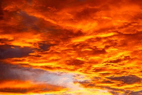 Vibrant sunset sky with dramatic orange and red cloud formations Stock Photos