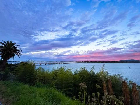 Vibrant sunset sky with dramatic orange and blue clouds New Zealand Fotos de archivo