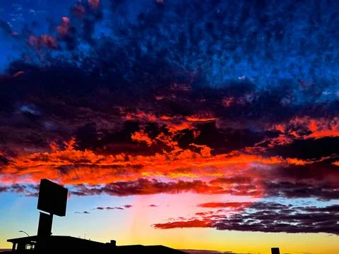 Vibrant sunset sky with dramatic orange and blue clouds New Zealand Фото