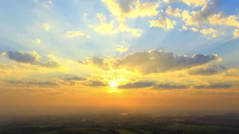 Vibrant Sunset Sky with Golden Clouds and Sun Rays Stock Footage 311530682