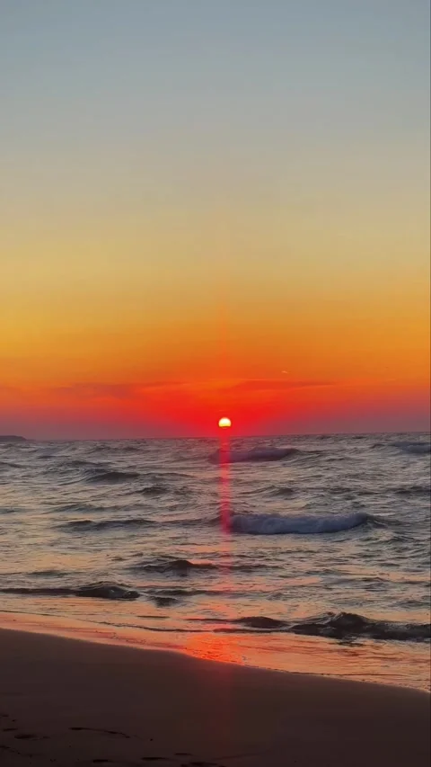 Vibrant Sunset Sun Over Ocean Horizon with Reflective Sea Waves Stock Footage 331968530