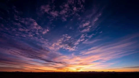 Vibrant sunset time lapse over desert horizon with purple and blue clouds Stock Footage 332874084
