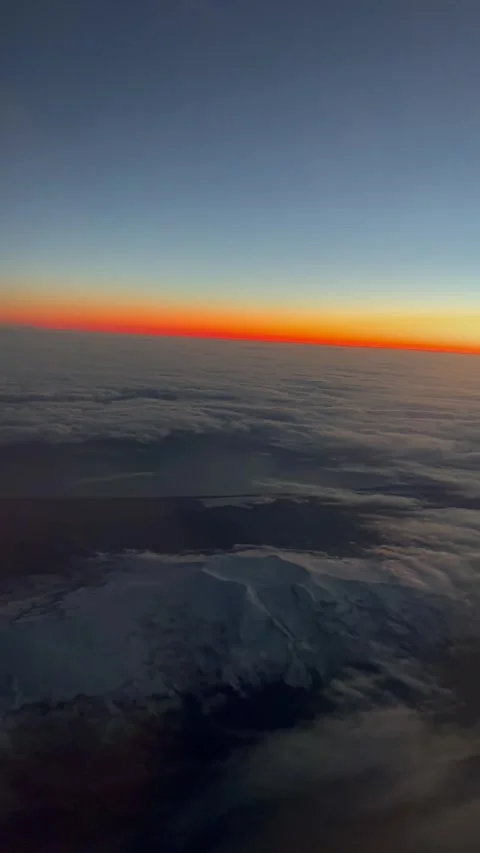 Vibrant Sunset View from Airplane Window Above Clouds Stock Footage 277950374