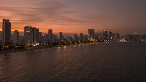 Vibrant sunset view over the coastal skyline of a bustling city Stock Footage 297930755
