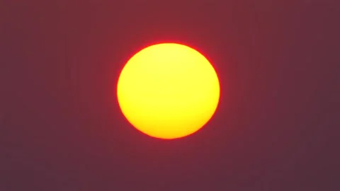 Vibrant sunset with warm glowing sun centered in rich red sky, Stock Footage 271667218