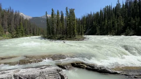 Vibrant Sunwapta Falls cascading down a rocky mountain range Stock Footage 202295101