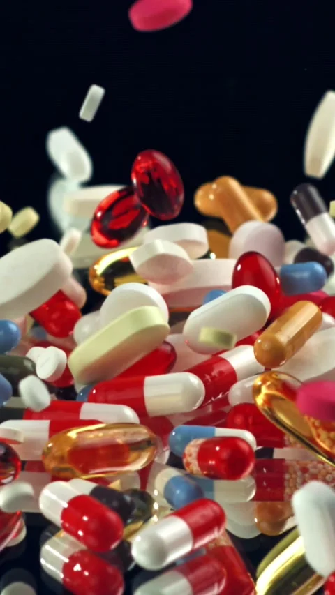 Vibrant supplements exploding above black reflective floor Filmed on a high Stock Footage 335396519