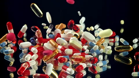 Vibrant supplements exploding above black reflective floor Filmed on a high Stock Footage 335423238