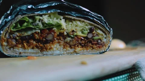 Vibrant tabletop view: beauty shot of a generous mexican burrito Stock Footage 342170873