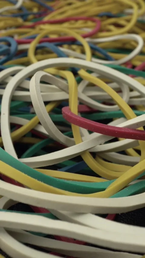 Vibrant tangled elastic bands in assorted colors forming a textured heap.  Stock Footage 342085129