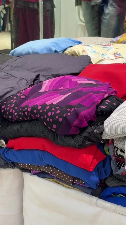 Vibrant textile stacks highlight diverse fashion offerings in a contemporar.. Stock Footage 326037128