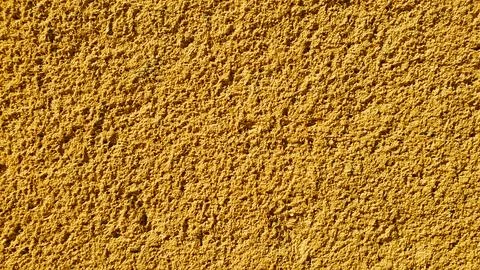 A vibrant textured surface featuring a bright yellow hue with a grainy, sto.. 스톡 일러스트