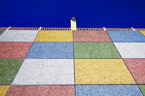 Vibrant Textured Wall under Deep Blue Sky Stock Photos