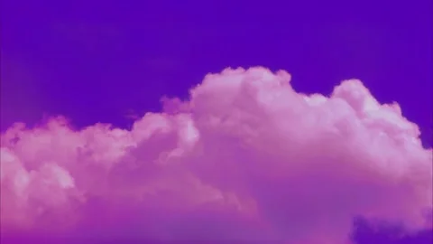 Vibrant time lapse of cotton pink clouds moving across a deep cobalt blue sky Stock Footage 337421678