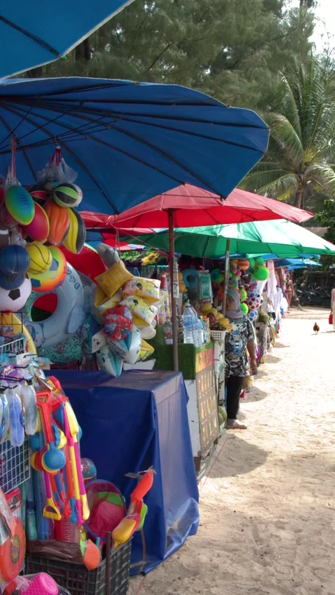 Vibrant Tropical Fruit and Beach Gear Market Stall in Phuket Thailand Stock Footage 331048869