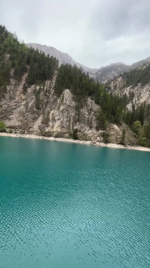 Vibrant Turquoise Lake Surrounded by Forested Mountains in Jiuzhaigou Valley Stock-Footage 337007797