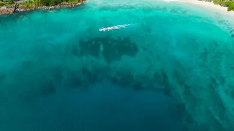 Vibrant turquoise water with a distant shore. Seychelles, Mahe. Stock Footage 303551663