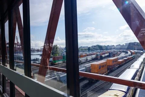 Vibrant view through red-framed windows of Vancouver's rail yard and port, .. Stock Photos