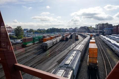 Vibrant view through red-framed windows of Vancouver's rail yard and port, .. Stock Photos