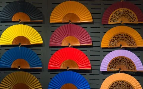 Vibrant wall display showcasing an array of vivid multicolored fans 写真素材