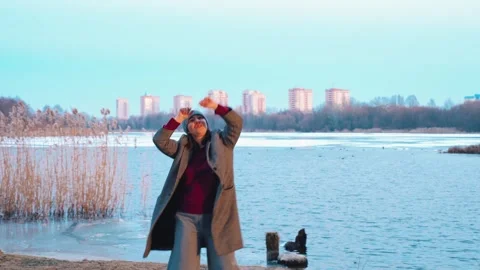 Vibrant water dancer, Dynamic performer near icy river interacts with elegant Stock Footage 324966303