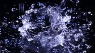 Vibrant Water Falling And Splashing On Dark Surface In Slow Motion Stock Footage