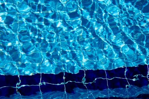 Vibrant Water Patterns Reflecting Sunlight in a Clear Swimming Pool on a Bright Stock Photos