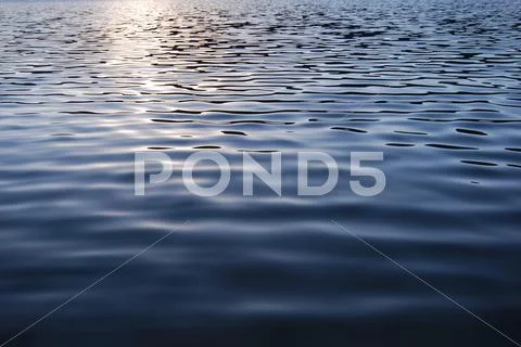 Vibrant water texture with sunlight reflection Stock Photos