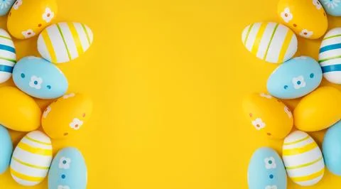 Vibrant yellow background with colorful Easter eggs Stock Photos