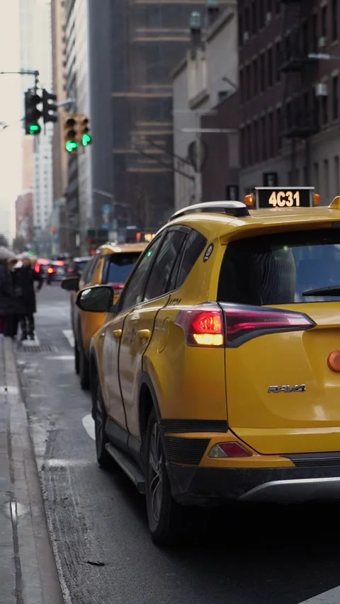 The vibrant Yellow Cabs navigating through the bustling Urban Cityscape Traffic Vídeo Stock 295070790