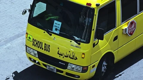 A vibrant yellow school bus, adorned with SCHOOL BUS text. Stock Footage 311885836